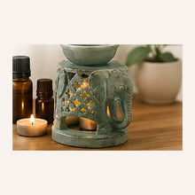 Hand-carved marble elephant oil burner illuminated with a tealight